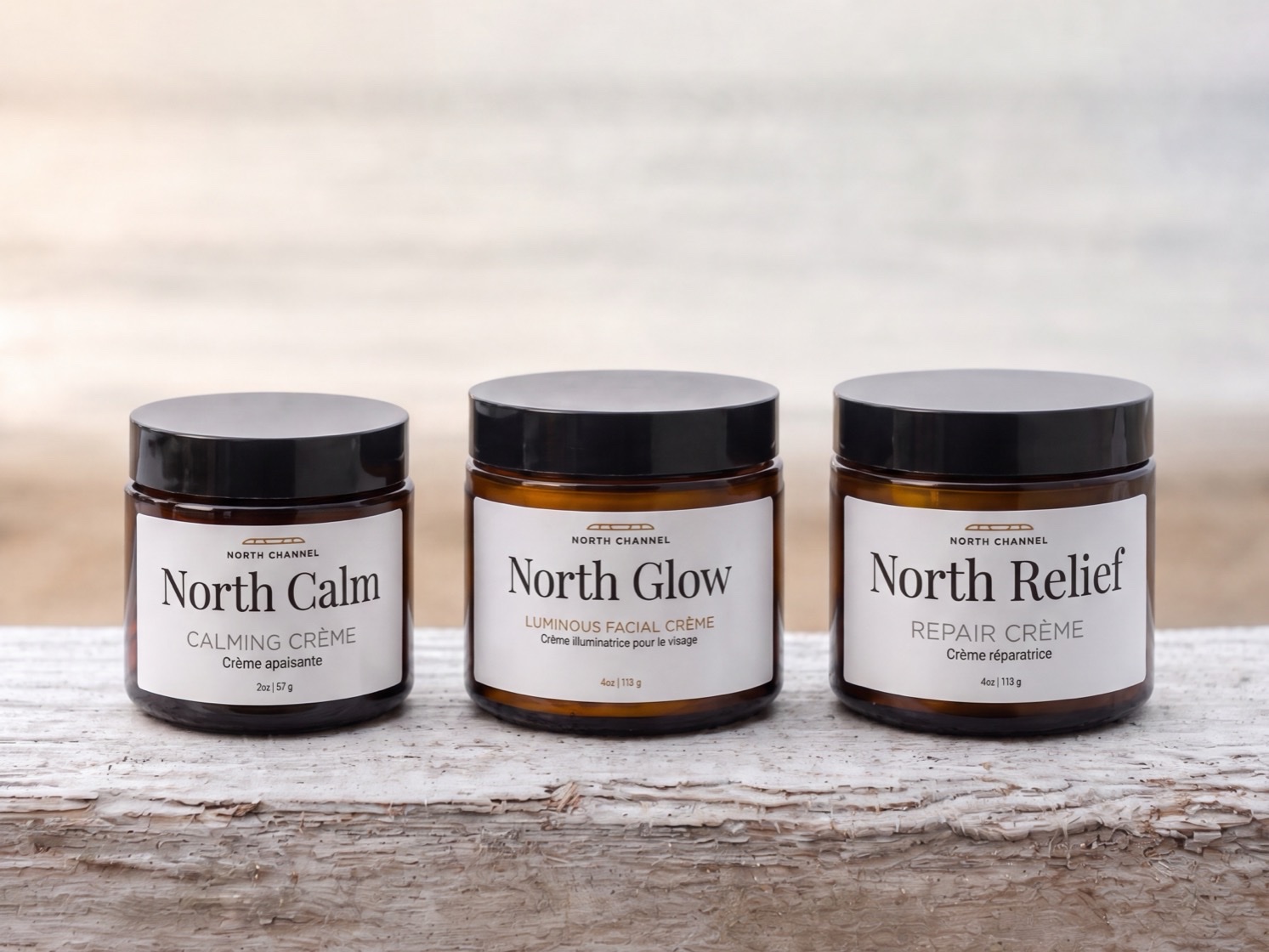The North Channel collection on weathered driftwood by the water: North Calm, North Glow and North Relief, left to right